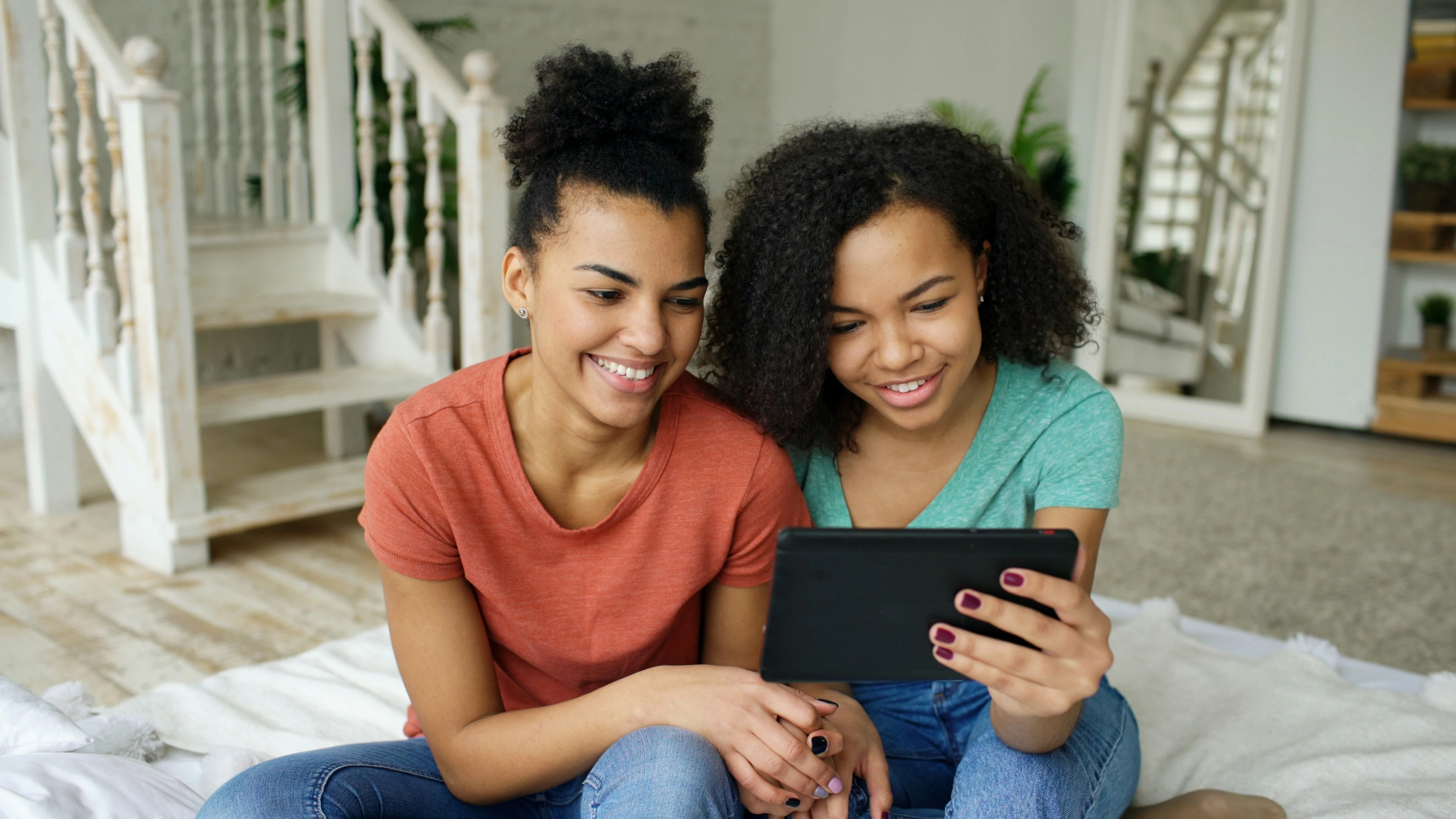 Two students studying together on a tablet